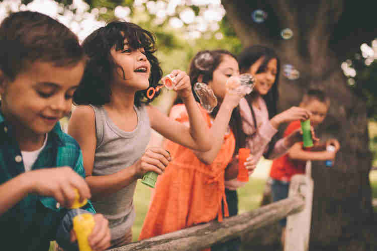 Photo of children blowing bubbles