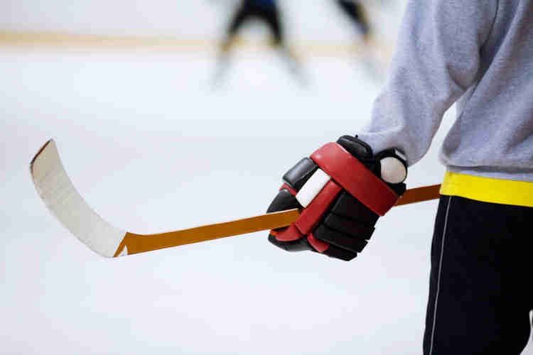 Photo of a person holding a hockey stick