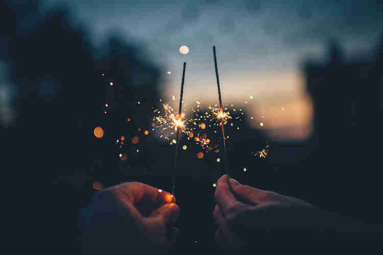 two hands holding a sparkler