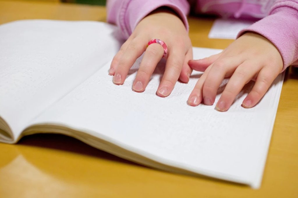 Image of child hands on an open notebook