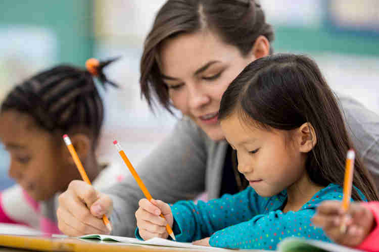 Image of a teacher helping a student