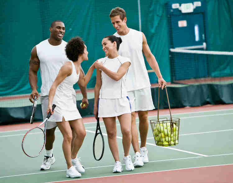 Image of two men and two women on a tennis court